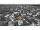 An aerial view shows the home's location in a quiet neighborhood near a lake at 4508 Compass Oaks Dr, Valrico, FL 33596