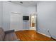 Bedroom view featuring hard wood floors, a TV, double closet, and view to the bathroom at 4508 Compass Oaks Dr, Valrico, FL 33596
