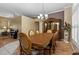 A formal dining room features wood table and chairs with a decorative chandelier and hutch at 4508 Compass Oaks Dr, Valrico, FL 33596