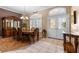 Elegant dining room featuring tile flooring, decorative front doors, and a stylish table with chairs at 4508 Compass Oaks Dr, Valrico, FL 33596
