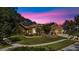 Charming single-story home with well-manicured lawn, mature landscaping, a fountain, and a three-car garage at 4508 Compass Oaks Dr, Valrico, FL 33596