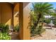 Charming front porch with lush landscaping, a decorative chair, and a welcoming garden at 4508 Compass Oaks Dr, Valrico, FL 33596