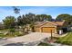 Well-maintained home with a two-car garage, solar panels, manicured lawn, and mature landscaping at 4508 Compass Oaks Dr, Valrico, FL 33596