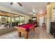 Enclosed patio and game room featuring a billiards table, tiled flooring, and lots of natural light at 4508 Compass Oaks Dr, Valrico, FL 33596