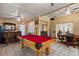 Spacious game room featuring a billiards table, bar area, and a seamless transition to the outdoors at 4508 Compass Oaks Dr, Valrico, FL 33596