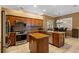 Eat-in kitchen with granite countertops, an island, tile flooring, and stainless steel appliances at 4508 Compass Oaks Dr, Valrico, FL 33596