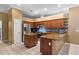 Kitchen featuring granite countertops, wood cabinetry, tile flooring, and modern stainless steel appliances at 4508 Compass Oaks Dr, Valrico, FL 33596