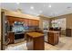 Eat-in kitchen with granite countertops, an island, tile flooring, and stainless steel appliances at 4508 Compass Oaks Dr, Valrico, FL 33596