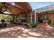 Outdoor patio space featuring comfortable seating, a covered area, and lush potted plants, ideal for relaxation and entertainment at 4508 Compass Oaks Dr, Valrico, FL 33596