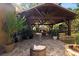 Covered outdoor patio featuring wood ceiling, stone fireplace, and brick flooring, creating an inviting outdoor living space at 4508 Compass Oaks Dr, Valrico, FL 33596