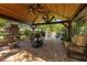 Beautiful covered patio with a stone fireplace, ceiling fans, comfortable seating, and a well-maintained brick-paved floor at 4508 Compass Oaks Dr, Valrico, FL 33596