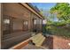 Screened-in porch extends to a cozy backyard with wooden steps leading to a tranquil outdoor space at 4733 W Vasconia St, Tampa, FL 33629