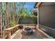 Intimate backyard featuring a stone fire pit and wooden seating, perfect for outdoor gatherings at 4733 W Vasconia St, Tampa, FL 33629