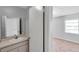 Bathroom with vanity featuring a neutral counter-top, and doorway to a bedroom at 4733 W Vasconia St, Tampa, FL 33629