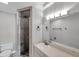 Bathroom featuring walk-in shower with rock floor, vanity, and modern lighting at 4733 W Vasconia St, Tampa, FL 33629