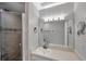 Bathroom with vanity, modern lighting, and a walk-in shower with decorative accents at 4733 W Vasconia St, Tampa, FL 33629
