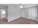 Cozy bedroom features carpeted floors, a ceiling fan, and a double-door closet at 4733 W Vasconia St, Tampa, FL 33629