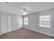 Bright bedroom featuring carpeted floors, two closets, and natural light from two windows at 4733 W Vasconia St, Tampa, FL 33629