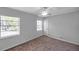 Well-lit bedroom with neutral walls, plush carpeting, and two large windows at 4733 W Vasconia St, Tampa, FL 33629