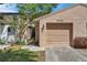 Inviting home exterior with a garage, gated walkway, and well-manicured landscaping, showcasing curb appeal at 4733 W Vasconia St, Tampa, FL 33629
