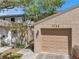 Charming home exterior boasts a garage, gated walkway, and beautiful landscaping, creating a welcoming atmosphere at 4733 W Vasconia St, Tampa, FL 33629