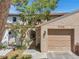 Inviting home exterior featuring a garage, gated walkway, and well-maintained landscaping, enhancing curb appeal at 4733 W Vasconia St, Tampa, FL 33629