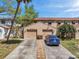 Charming townhouse featuring a two-car garage, landscaped yard, and inviting curb appeal at 4733 W Vasconia St, Tampa, FL 33629