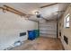 Spacious garage featuring an automatic door opener, storage beams, and ample space for vehicles and organization at 4733 W Vasconia St, Tampa, FL 33629