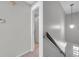 Upstairs hallway with view of the stairs and doorway to another room at 4733 W Vasconia St, Tampa, FL 33629