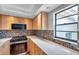 Updated kitchen featuring stainless steel appliances, tiled floors and ample countertop space at 4733 W Vasconia St, Tampa, FL 33629