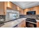 Bright kitchen featuring wood cabinets, mosaic backsplash, and modern appliances at 4733 W Vasconia St, Tampa, FL 33629