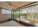 Screened-in lanai with ceiling fan and view of lush landscaping at 4733 W Vasconia St, Tampa, FL 33629