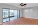 Living room featuring tile flooring, neutral walls, ceiling fan, and access to a screened-in lanai at 4733 W Vasconia St, Tampa, FL 33629
