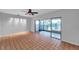Bright living room featuring tile flooring, a ceiling fan, and access to a screened-in lanai at 4733 W Vasconia St, Tampa, FL 33629