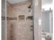 Close up of shower featuring decorative tile accents and a built-in soap niche at 4733 W Vasconia St, Tampa, FL 33629