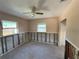 Bedroom featuring ceiling fan, two windows, and partially removed drywall, highlighting the renovation opportunity at 4911 Largo Ter, New Port Richey, FL 34652