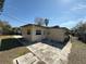 Rear view of a home featuring a door to the backyard and a neutral color scheme at 4911 Largo Ter, New Port Richey, FL 34652