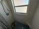 Shower needing repairs with a window, seat, and aqua tile floor at 4911 Largo Ter, New Port Richey, FL 34652