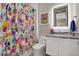 Vibrant bathroom with colorful shower curtain, modern vanity, and bright decor, creating an inviting space at 511 45Th N Ave, St Petersburg, FL 33703