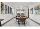Elegant dining room with a wooden table, modern chairs, and a stylish wine rack feature at 511 45Th N Ave, St Petersburg, FL 33703