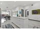 Bright kitchen with white cabinets, an island, and an open layout that connects to the dining area at 511 45Th N Ave, St Petersburg, FL 33703