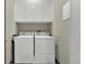 Efficient laundry room with white washer, dryer, and overhead cabinets, maximizing space for easy cleaning at 511 45Th N Ave, St Petersburg, FL 33703