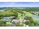 Sprawling community aerial view showcasing golf course, tennis courts, pool and large community center at 5115 Tobermory Way, Bradenton, FL 34211