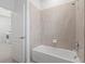 Bright bathroom featuring a white tub and tiled shower at 5115 Tobermory Way, Bradenton, FL 34211