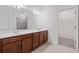 Bathroom with double sinks, white countertop and wood cabinets at 5115 Tobermory Way, Bradenton, FL 34211