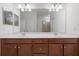 Bathroom with double sinks, white countertop and wood cabinets at 5115 Tobermory Way, Bradenton, FL 34211