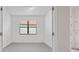 Bright bedroom featuring a window with blinds and neutral carpet at 5115 Tobermory Way, Bradenton, FL 34211