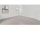 Spacious carpeted bedroom with a large window and natural light at 5115 Tobermory Way, Bradenton, FL 34211
