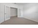 Bedroom with neutral carpet and glass paneled doors leading to another room at 5115 Tobermory Way, Bradenton, FL 34211