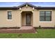 The charming front entrance features a brick walkway and a glass-paneled front door flanked by two rectangular windows at 5115 Tobermory Way, Bradenton, FL 34211